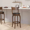 Sgabello da bar girevole in legno con sedile imbottito in similpelle